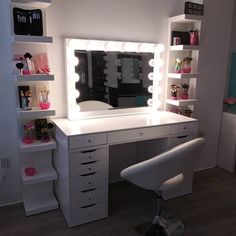 a white desk topped with a mirror and lots of drawers next to a shelf filled with cosmetics