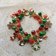 This Christmas charm bracelet is approx. 8 inches long and surrounded by green and red glass beads and holiday charms. #10 Christmas Holiday Green Jewelry, Green Christmas Holiday Jewelry, Green Charm Bracelet With Lobster Clasp As Gift, Green Beaded Bracelets For Christmas, Green Christmas Jewelry For Festive Occasion, Green Beaded Bracelet For Holiday, Green Bracelet Jewelry For Holiday, Green Christmas Gift Bracelets, Green Christmas Bracelet Gift