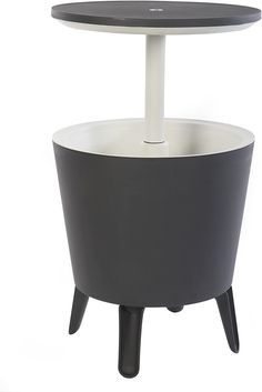 a black and white round table with an umbrella on it's top, sitting in front of a white background