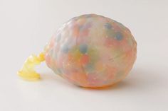 there is a gummy ball with a yellow rubber band around it