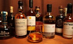 several different types of whiskey bottles lined up on a table