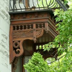 an old wooden balcony with wrought iron railing