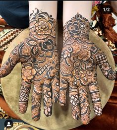 two hands with henna designs on them