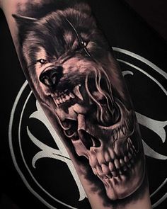 a man's arm with a tattoo on it and a wolf skull in the middle