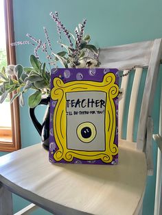 a vase filled with flowers sitting on top of a wooden table