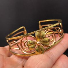 *Description: This is a beautiful 14 K rolled gold overlay Krementz cuff bracelet featuring a gold four leaf clover in the center. The open work makes the bracelet light on your wrist. On the end of each side of the cuff is the KREMENTZ stamp. I acid tested the surface of the bracelet which tested at 14K gold. The inside is a magnetic unknown metal. The bracelet is six inches around the inside with 3/4 of an inch gap. This cuff bracelet would be a great gift or wonderful addition to your vintage Vintage Yellow Gold Brass Bangle, Victorian Gold Cuff Bracelet Gift, Heirloom Gold Cuff Bracelet Gift, Vintage Gold Brass Cuff Bracelet, Antique Gold Cuff Bracelet For Anniversary, Vintage Yellow Gold Hallmarked Cuff Bracelet, Adjustable Gold Victorian Cuff Bracelet, Unique Gold Cuff Bracelet For Collectors, Yellow Gold Wedding Bracelet