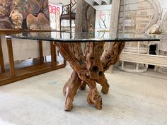 a table made out of wood with glass top in a room filled with chairs and tables