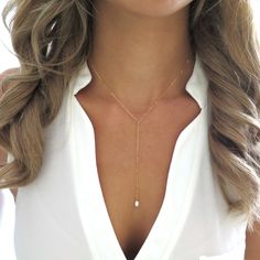 "This dainty y lariat necklace features a focal piece of a beautiful freshwater pearl hung on a 14k gold filled chain. The perfect piece of date night jewelry, this gold Y necklace is perfect for a plunging v neck! Shop Landon Lacey Jewelry: www.etsy.com/shop/landonlacey it's in the DETAILS . . . » 14k gold filled chain » Spring ring clasp » Freshwater pearl » The model is wearing this necklace at 15\" (doesn't include the drop), but she is petite and 15\" may sit shorter or longer depending on Simple Pearl Necklace, Gold Lariat Necklace, Back Necklace, Gold Long Necklace, Beaded Pendant Necklace, Trendy Necklaces, Long Pendant Necklace, Pearl Pendant Necklace, Lariat Necklace