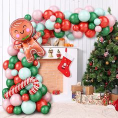 a christmas tree decorated with balloons, candy canes and gingerbread man balloon arch