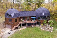 an aerial view of a house with two large domes on the roof and stairs leading up to it