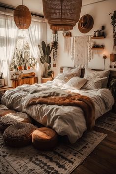 a large bed sitting in a bedroom on top of a wooden floor next to a window