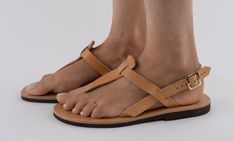 Elegant, refined, timeless and comfy, Athena is a veg-tanned leather sandal handmade in Greece by our sandal maker Pavlos in the same way his family has made them for generations. We added a natural rubber sole for comfort. Athena is available in gold, rose gold and natural!  Only available in full sizes, go up to the nearest whole size if you take a half size. Natural Toe Loop Sandals With Leather Sole, Natural Color Vegetable-tanned Sandals With Round Toe, Natural Vegetable-tanned Sandals With Round Toe, Natural Vegetable-tanned Round Toe Sandals, Summer Vegetable-tanned Natural Sandals, Natural Leather Flip Flops With Leather Sole, Natural Leather Toe Loop Huarache Sandals, Natural Leather Sandals, Leather Sandals Handmade