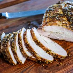 sliced pork on a cutting board next to a knife