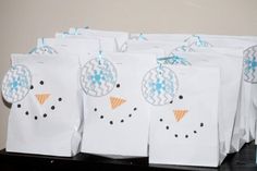 several bags with snowmen on them sitting on a table