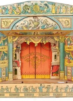 an elaborately painted wooden theatre set with red doors