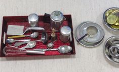 a tray with silverware and spoons sitting on a table