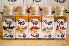 six spice bottles lined up on a table