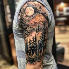 a man with a full sleeve tattoo on his arm and shoulder is looking at the moon