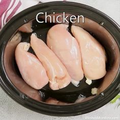 three pieces of raw chicken in a slow cooker with the words chicken on it