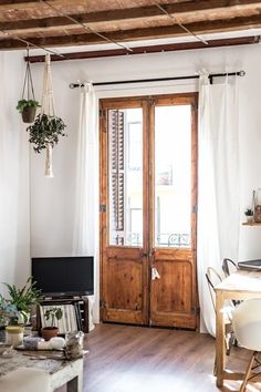 a living room filled with furniture and a wooden door