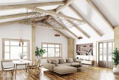 an open concept living room with wood floors and exposed beams on the ceiling is shown