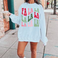 Fa La La your way all through this Christmas Season in our festive Holiday sweatshirt. Our adorable and cozy Fa la la la sweatshirt will have you in the Christmas spirit in no time! Grab your hot cocoa and enjoy the holiday season in our fun and cheerful Christmas sweatshirts. Fa La La Sweatshirt, Christmas Shirt, Cute Christmas Shirt, Christmas sweatshirt, Holiday shirt, Christmas Shirt for Women, gifts, Ideal for any situation, a unisex heavy blend crewneck sweatshirt is pure comfort. These ga Fun White Sweatshirt For Winter, Fun Crew Neck Winter Sweatshirt, Fun Winter Crew Neck Sweatshirt, Fun Crew Neck Winter Tops, Fun Winter T-shirt With Crew Neck, Fun Crew Neck Tops For Winter, Casual White Christmas Sweater, Fun White Winter Tops, Winter Fun Relaxed Fit Tops