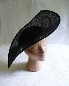 "One large sinamay straw hat base in black in an oblong shape that measures approximately 13\" (33.00 cm) at its widest point and approximately 17\" (43.18 cm) at its longest point. Deep curvature to fit against your head. The stiffened sinamay straw is feather light but has a great sturdy weave that provides excellent support for your millinery creations. Edge finished with sinamay. Shipped in an oversized box, hence the higher than normal postage charge. May have to ship separately for some in Classic Black Boater Hat For Party, Fitted Black Hat For Royal Ascot, Fitted Black Costume Hat For Royal Ascot, Elegant Black Sinamay Hat, Fitted Brimmed Top Hat For Church, Fitted Black Fascinator For Summer, Fitted Top Hat With Curved Brim For Evening, Black Summer Fascinator, Black Boater Hat For Summer Wedding