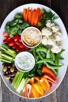 a white plate topped with veggies and dip