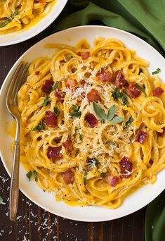 a plate of pasta with bacon and parmesan cheese