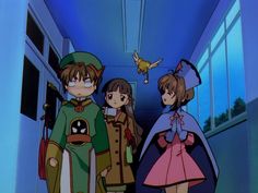 three anime characters are standing in a hallway