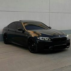 a black car parked in front of a building