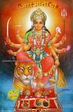 the hindu goddess sitting on top of a tiger