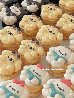 there are many decorated cupcakes with teddy bears on them in the shape of snowmen