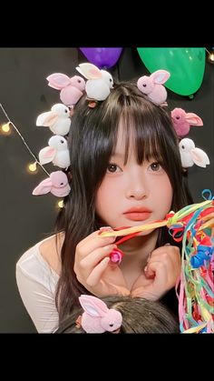 a girl with bunny ears holding a toothbrush in front of her face