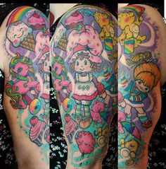 the back of a woman's thigh with tattoos on her legs and an image of cartoon