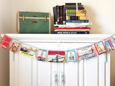 there is a book shelf with books on it and a suitcase next to the bookshelf