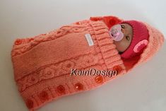 a baby doll in a pink knitted hat