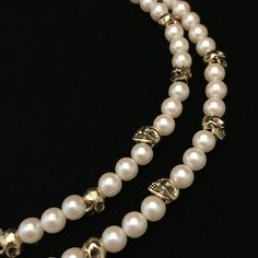 This necklace is a combination of new and vintage pieces. Circa 1960 faux pearls are mixed with twenty contemporary, gold plated skull beads. The skulls and pearls are both about the same size, 3/8 inch, or 8 mm. It has been strung on thick beading wire and both strands end in a vintage, gold plated closure component original to the necklace. A raw brass skull has been added to the large, 1 inch tongue in socket closure. It is a double strand necklace measuring 16 and 17 inches.  There are twent Classic Metal Jewelry With Pearl Chain, Classic Metal Pearl Chain Jewelry, Classic Metal Jewelry With Pearl Drop, Beaded Metal Pearl Necklace With Round Beads, Beaded Double Strand Jewelry For Jewelry Making, Double Strand Beaded Jewelry For Jewelry Making, Double Strand Pearl Drop Jewelry, Pearl White Beaded Metal Jewelry, Formal Costume Jewelry With Pearl Drop