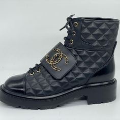 Chanel 2022 (22k Season) Calfskin Leather Lace Up Combat Boots With 1.25" Stacked Heel. Shiny Calfskin Leather Cap Toe And Backstay. Goldtone Chain And Leather Interwoven Cc Logo On The Front Leather Flap. Padded Leather Insole. Rubber Sole. Shaft: 5". Made In Italy. Designer Color: Black. Size: 38.5 Eu (Insole Approx. 9 7/8"). Typically Chanel Shoes Run Small. Brand New With The Box And A Dust Bag. Black Magic Book, Lace Up Combat Boots, Leather Cap, Moto Boots, Chanel Shoes, Quilted Leather, Leather Chain, Stacked Heel, Leather And Lace