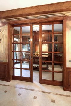 an empty room with wooden doors and tile flooring