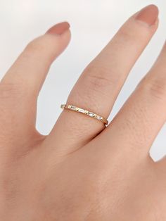 Beautiful Baguette Diamond Wedding Band/Stacking Ring. A bar setting makes this ring unique and modern. Available in any color 14K Gold. Great accent for stacking, for special occasions, or wedding bands! Available in sizes 4.5-10! Approx Gold Weight: 1.25g 14k Gold Approx Diamond Weight: 0.23cts 6 Diamonds, SI clarity & GH color *Shop Policies:* SHIPPING: All purchases are processed within 1-2 business days. Items that are made to order will be shipped within the projected date shared with Rose Gold Baguette Diamond Wedding Jewelry, Gold Eternity Band With Baguette Diamonds For Anniversary, Elegant Gold Eternity Band With Baguette Diamonds, Delicate Baguette Diamond Jewelry For Anniversary, Gold Eternity Band With Baguette Cut For Promise Ring, Gold Half Eternity Baguette Cut Jewelry, Wedding Eternity Band With Baguette Cubic Zirconia, Gold Baguette Cut Eternity Band As Promise Ring, Minimalist Channel Set Diamond Wedding Ring