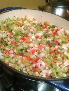 a pan filled with chopped vegetables on top of a stove