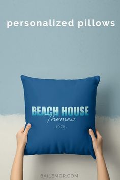 someone is holding up a pillow that says beach house miami in blue on the front