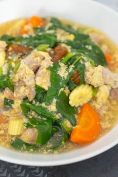 a white bowl filled with soup and vegetables