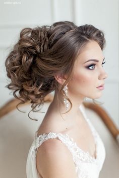 an image of a woman with long hair in her wedding dress and wearing earrings on her head