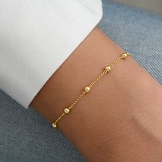 "Dainty bracelet featuring 3mm balls. It's perfect for layering or on its own! Matching Necklace Available! https://www.etsy.com/listing/1171312517/satellite-chain-necklace-layering?click_key=108f0a959c980feb673cd5ec65c6adcfc7432fde%3A1171312517&click_sum=51edd237&ref=shop_home_active_16&pro=1&sts=1 - - - D E T A I L S - - - * Made of 925 Sterling Silver * We use a THICK plating of 14k Gold or Rhodium * Nickel-free & Hypoallergenic * Balls measure 3mm * Available in 5.5\" (kids), 6.25\" or 6.75\ Delicate Bracelet Gold Simple, Matching Gold Bracelets, Simple Gold Bracelets For Women, Dainty Bracelets Gold, Gold Bracelet For Women Classy, 14k Gold Bangle Bracelet, Gold Bead Bracelet, Gold Bracelet Simple, Silver Opal Ring