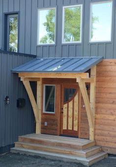 a small wooden building with a metal roof