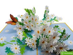 some white flowers and a butterfly on a blue table