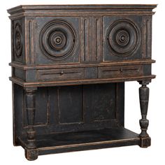 an old wooden cabinet with carvings on the front and side panels, sitting against a white background