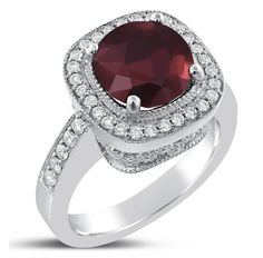 a ring with a large red stone surrounded by white diamonds